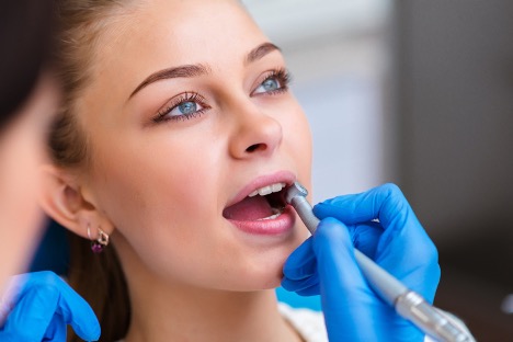 Woman getting her mouth checked out by the dentist